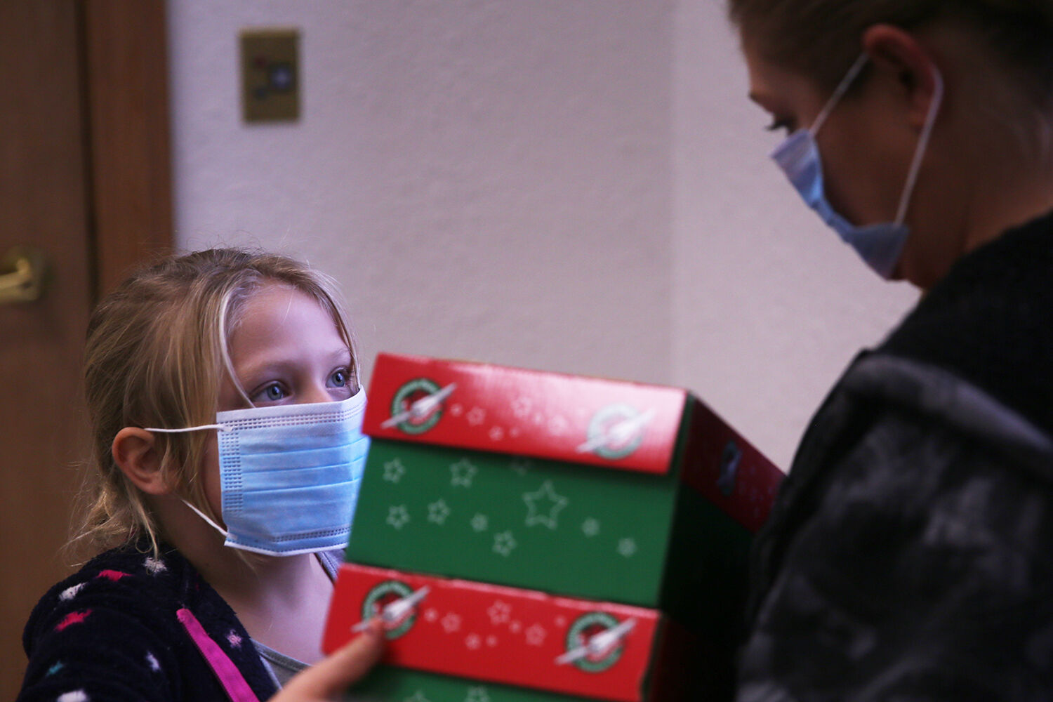 Natalie Roope, 6, grabs the boxes from her mom Shandra Hendricks